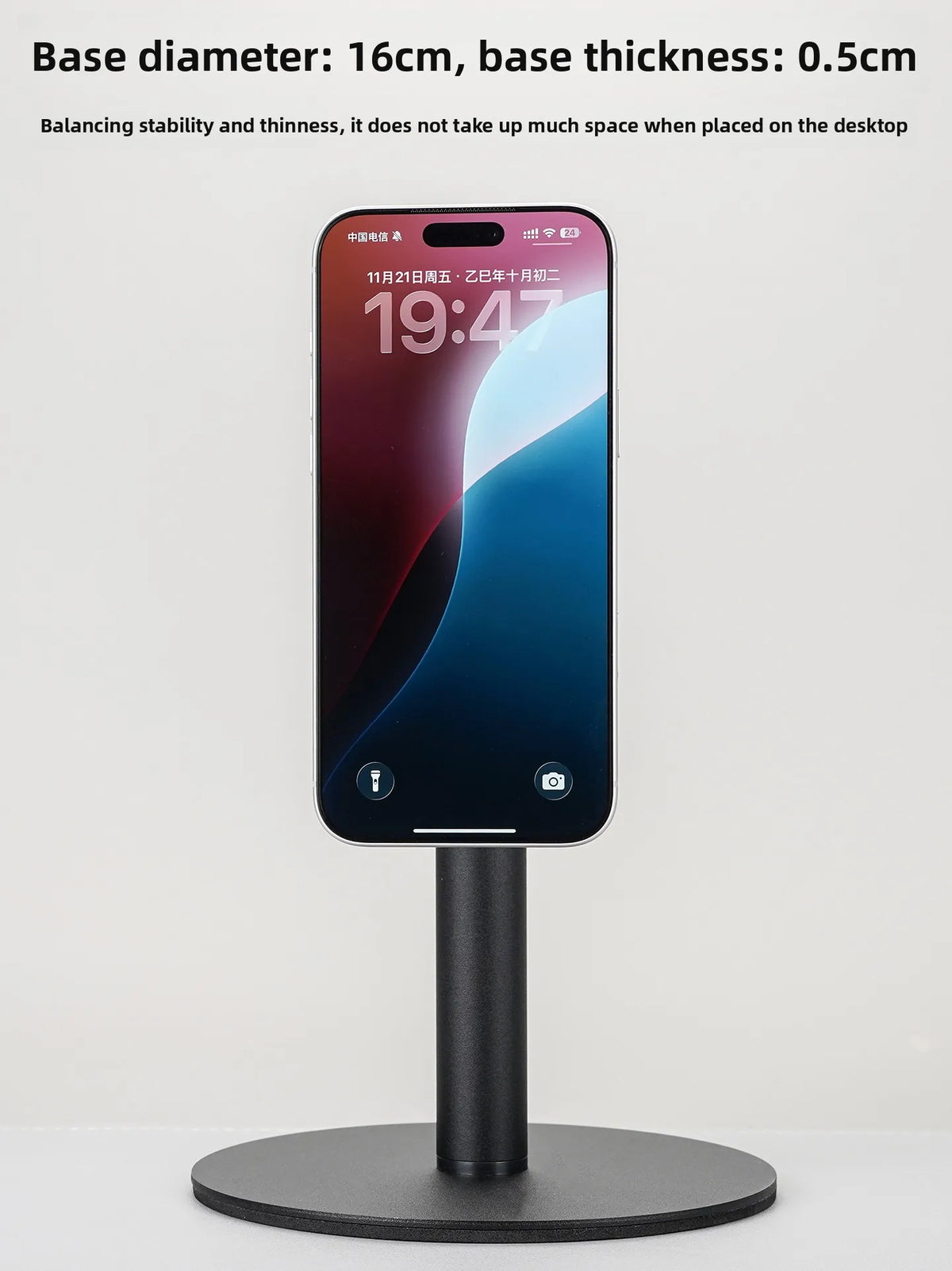 A black magnetic stand holding a smartphone, designed for balancing stability and desk placement.