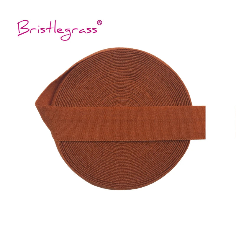 A brown, ribbed elastic hair tie or trim is shown flat against a white background.