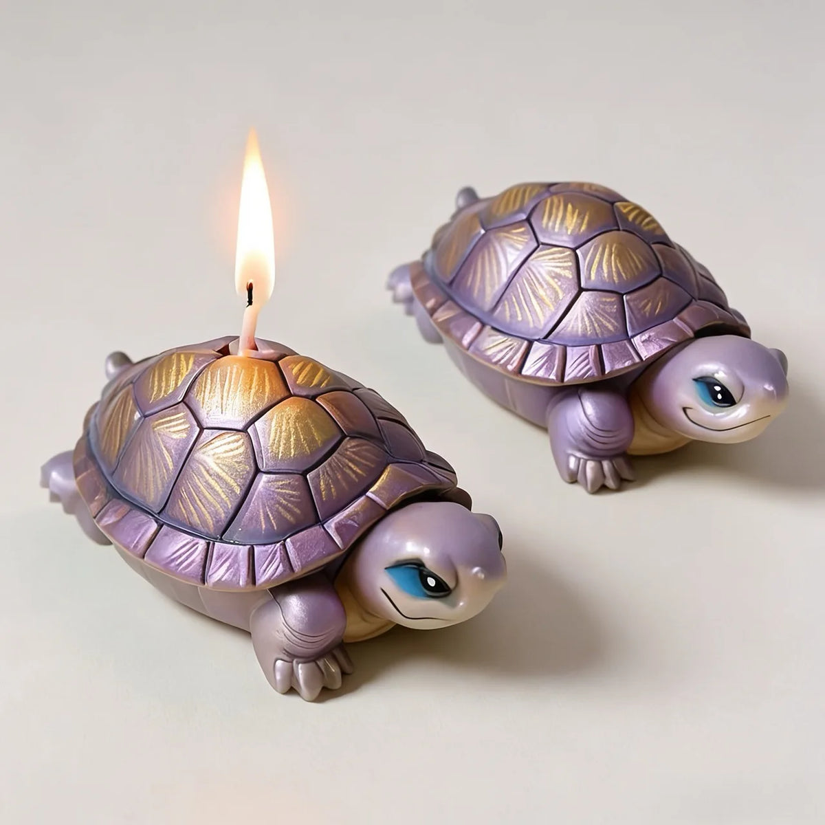 A small ceramic turtle figurine with a glowing candle on its back.