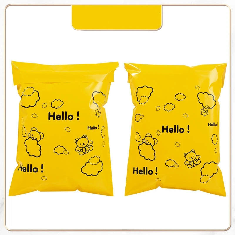 A yellow reusable plastic mailing bag filled with cute cloud and bear illustrations.