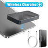 A magnetic wireless charging module is shown resting on a silver laptop, with a charging cable nearby.