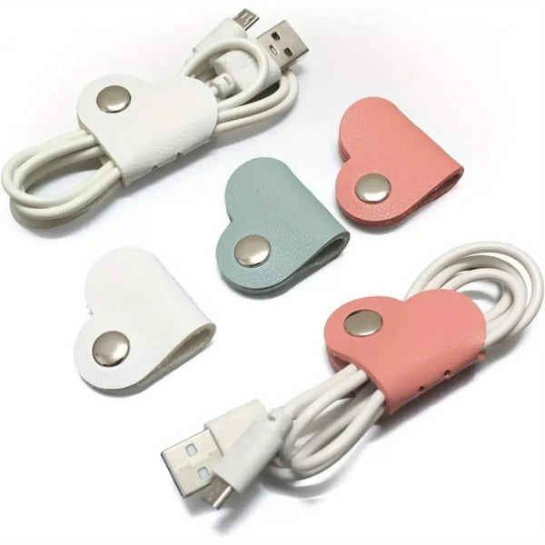A set of leather charge cable protectors and organizers in white and pink colors.