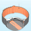 A silver watch with a gray face and orange accents is shown on a black strap.