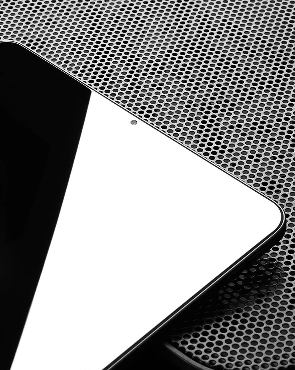 A close-up view of an iPad screen protector being applied to a device, showing the textured glass surface.