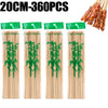 A set of natural bamboo skewers with green tips, packaged for cooking or grilling.