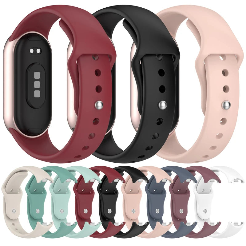A variety of silicone replacement straps and bands for Mi Band watches in various colors including red black pink and gray.