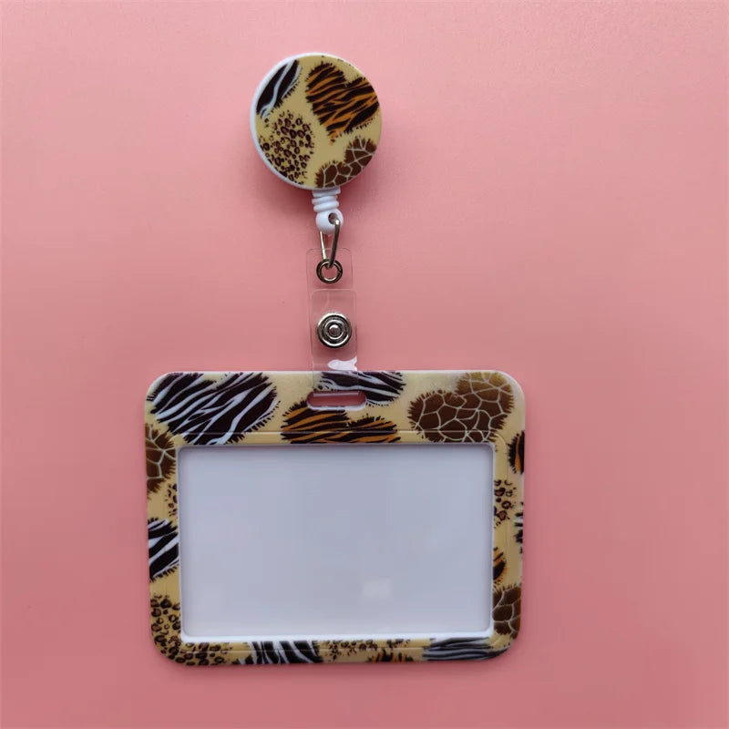 A leopard print card holder clip with a clear plastic ID holder and a round leopard print tag.