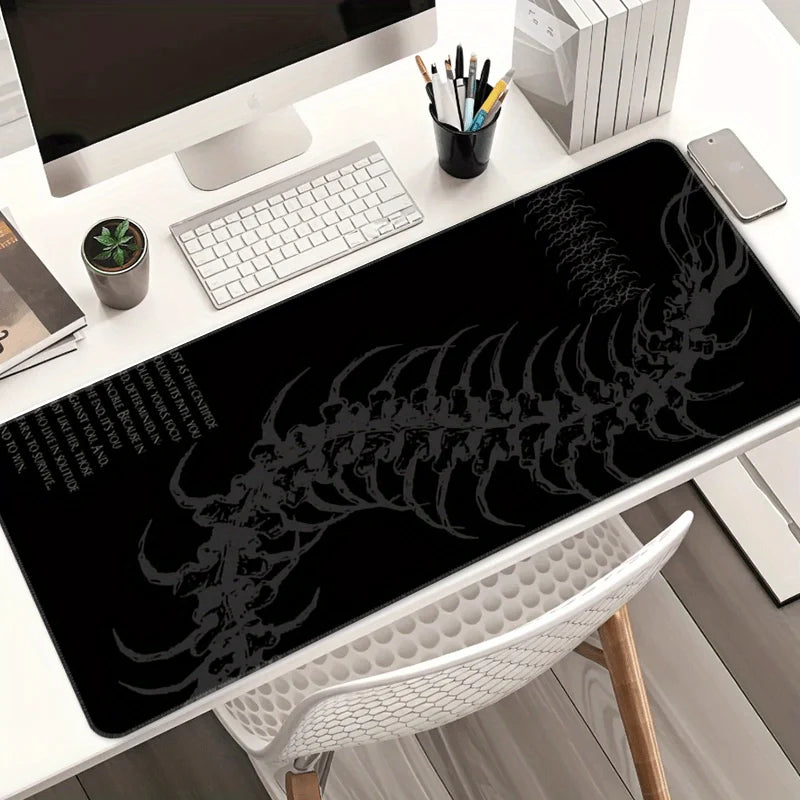 Black gaming mouse pad featuring a white gothic centipede design placed on a white desk.
