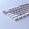 A close-up view of a row of light gray and pink PBT keycaps for an MX Mechanical keyboard.