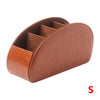 A brown PU leather caddy organizer with five compartments for storing TV remotes.