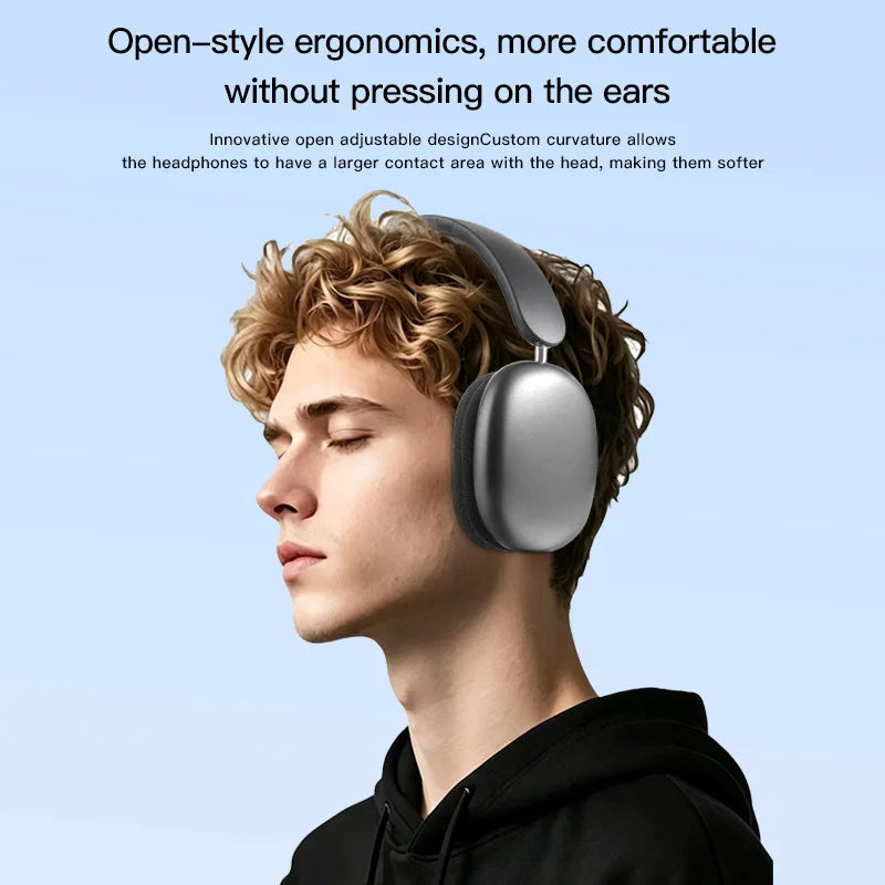 A young man wearing silver over-ear headphones with a large, smooth ear cup against a light blue background.