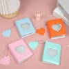 A collection of pastel colored hollow photo card binders in various shades including blue, orange, pink, and mint green.
