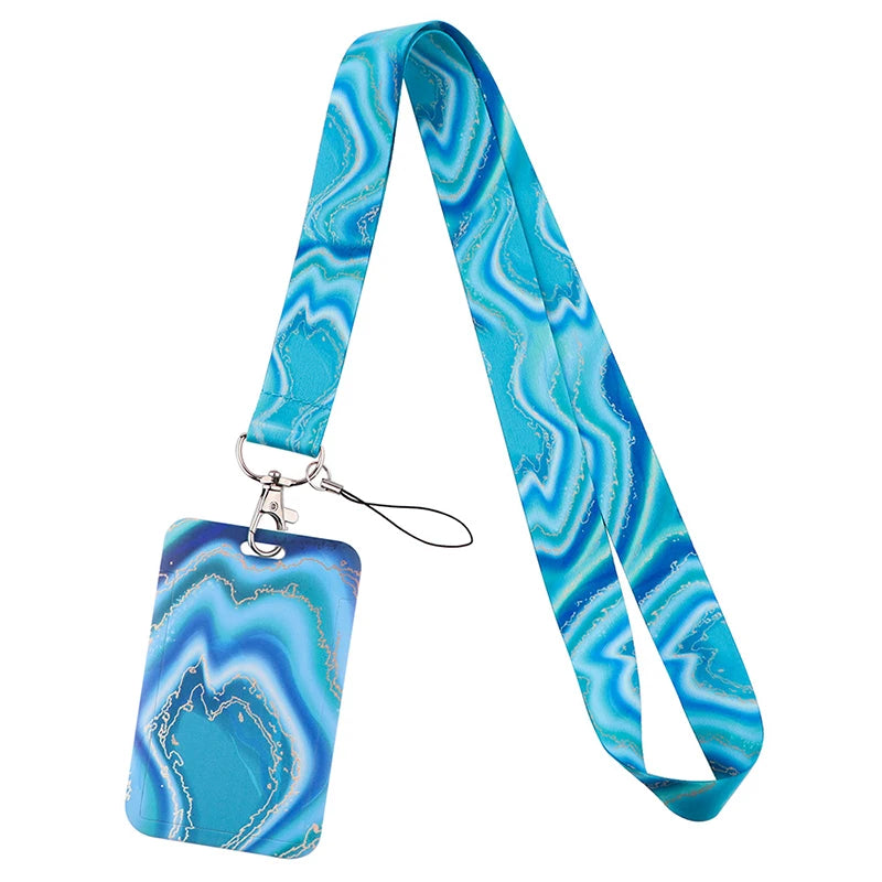 A turquoise and blue marbled silicone key lanyard with a clear acrylic tag.