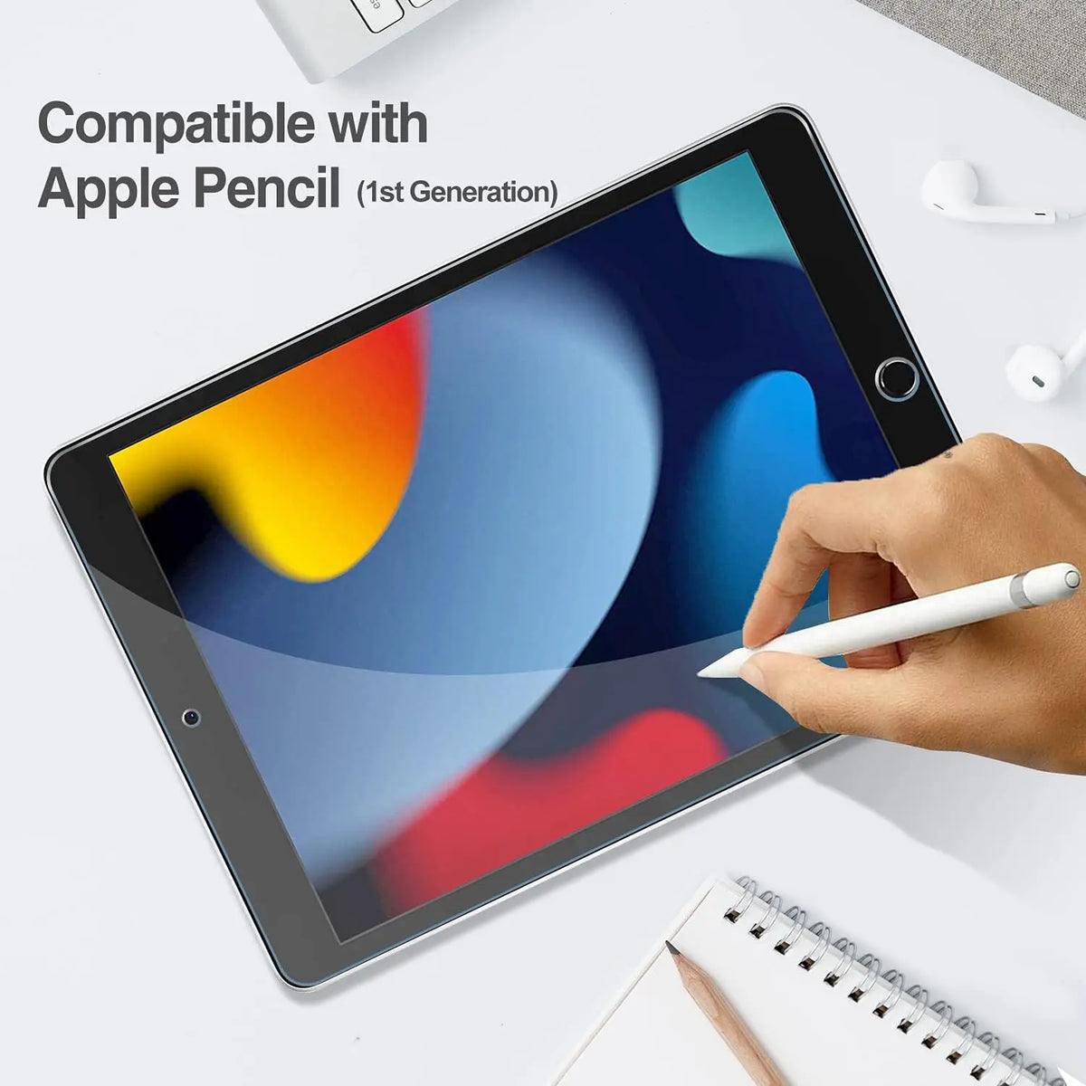 Una mano sostiene un lápiz óptico blanco escribiendo en una pantalla de iPad con protector de vidrio templado instalado.