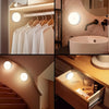 A collection of bathroom and interior lighting fixtures, including a vanity mirror with a motion sensor and wall sconces.