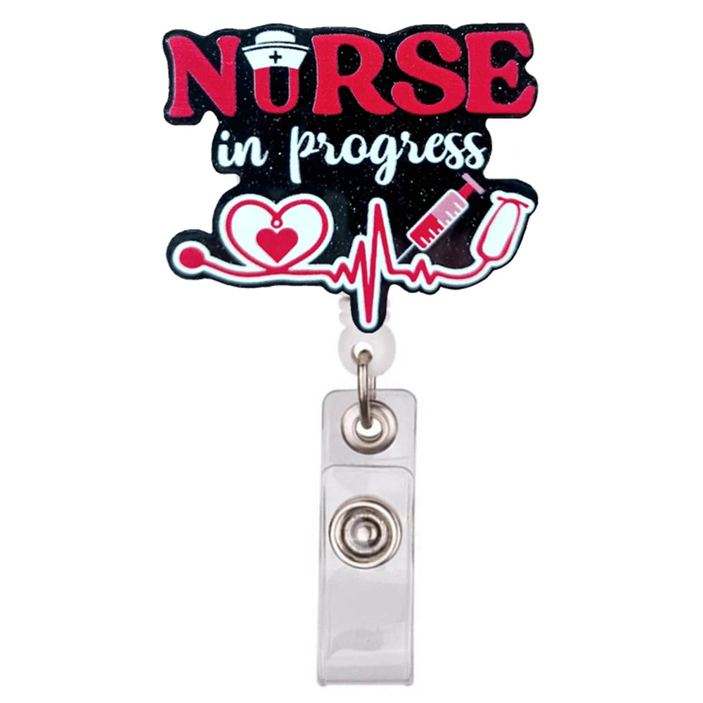 A black badge reel holder with the text NURSE in progress and a heart and ECG line design.