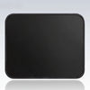 Black portable gaming mouse pad with a stitched edge shown on a reflective surface.