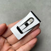 A silver personalized engraved money clip wallet is held in a person's hand.