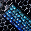 A close-up view of a mechanical keyboard featuring translucent blue keycaps with a cat eye stone theme.