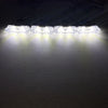 A strip of white LED emergency strobe lights illuminated against a dark background.