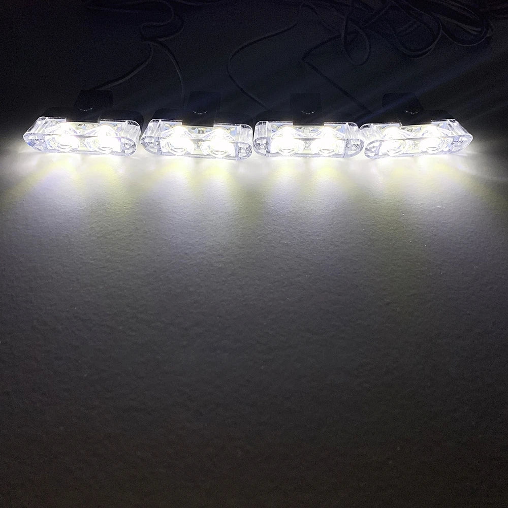 A strip of white LED emergency strobe lights illuminated against a dark background.