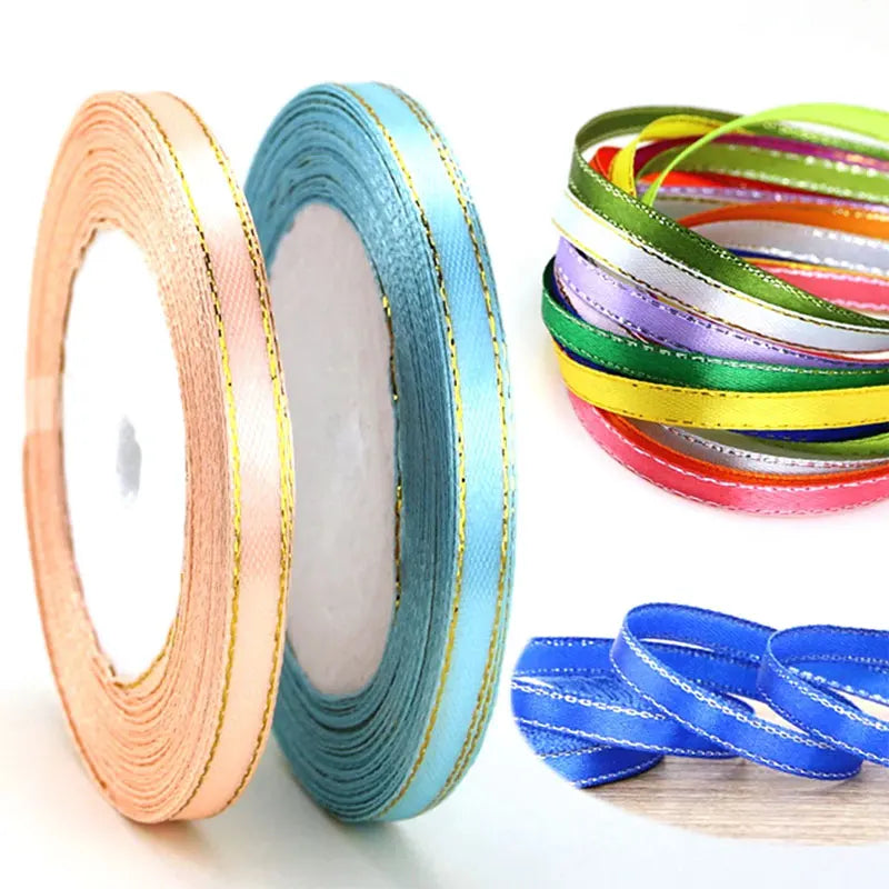Rolls of gold edge satin ribbon in various colors including teal and yellow