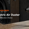 An orange and black Wolfbox MF50 Electric Air Duster is shown on a wooden surface with sawdust scattered around it.