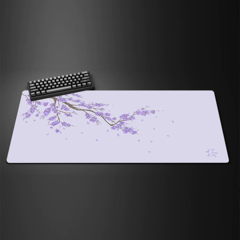 A light purple gaming mouse pad featuring a delicate branch of cherry blossoms and small pink flowers.