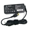 Black AC adapter for a laptop, featuring input/output specifications and a power cord.