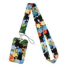 A colorful floral pattern card holder lanyard featuring cartoon cats and flowers on a fabric strap.