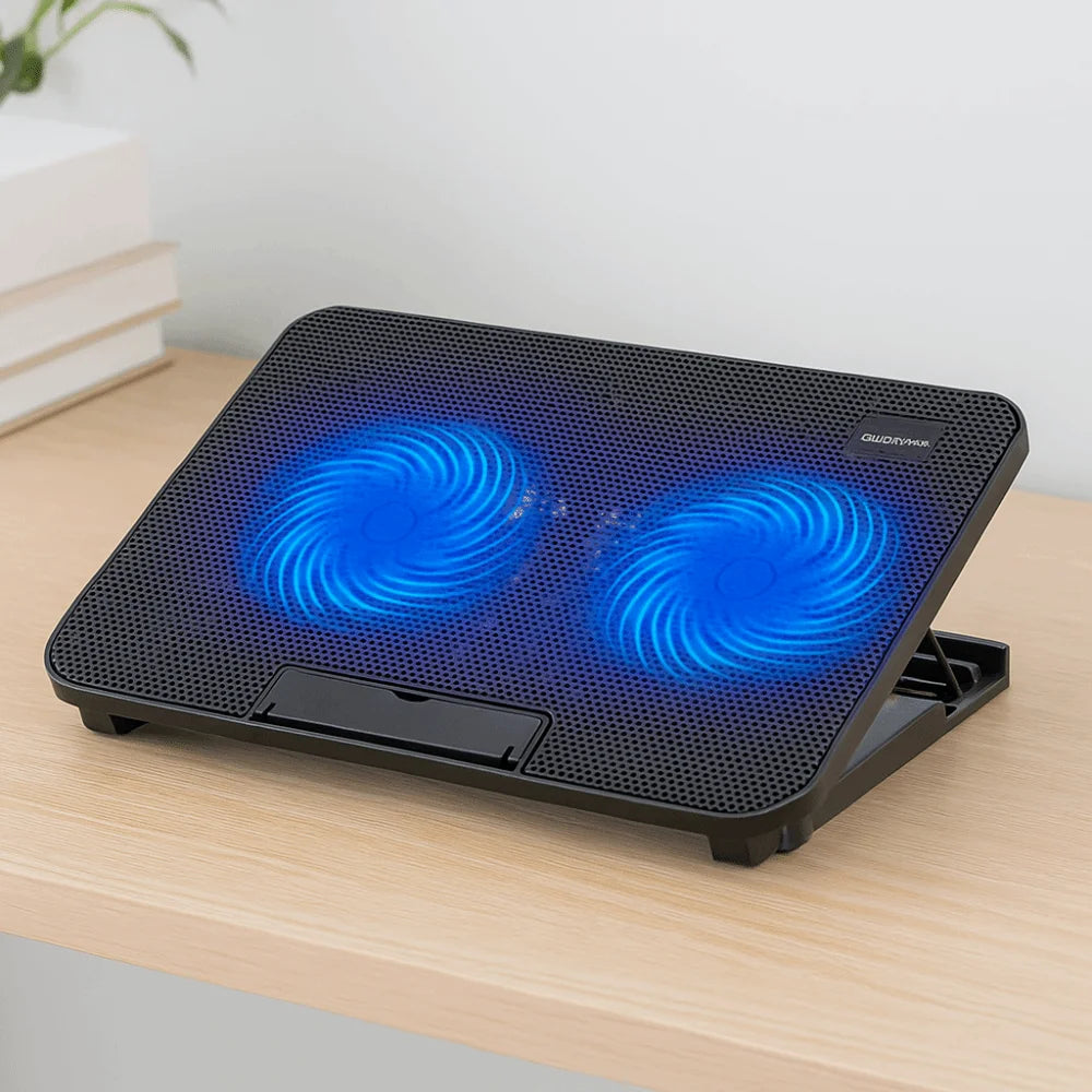 A black laptop cooling pad with integrated blue LED fans is shown on a wooden surface.
