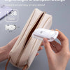 A beige fabric pouch containing a white LED book reading light, shown being held by hands.