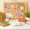 A framed display of pastel Halloween vinyl decals featuring cute ghosts, pumpkins, and desserts on a wooden background.