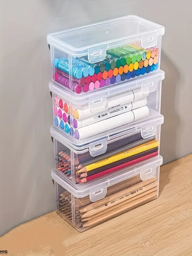 A stack of clear plastic storage boxes filled with various colored markers and pencils for office and craft supplies.