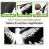 Black and white artistic angel wing design on a desk mat or mouse pad