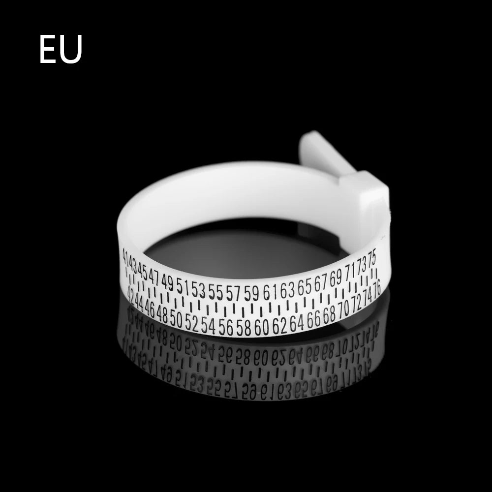 A white precision ring sizer and gauge tool with a circular scale is shown against a black background.