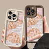 A hand holds an iPhone with a croissant newspaper pattern case featuring light beige and brown tones.