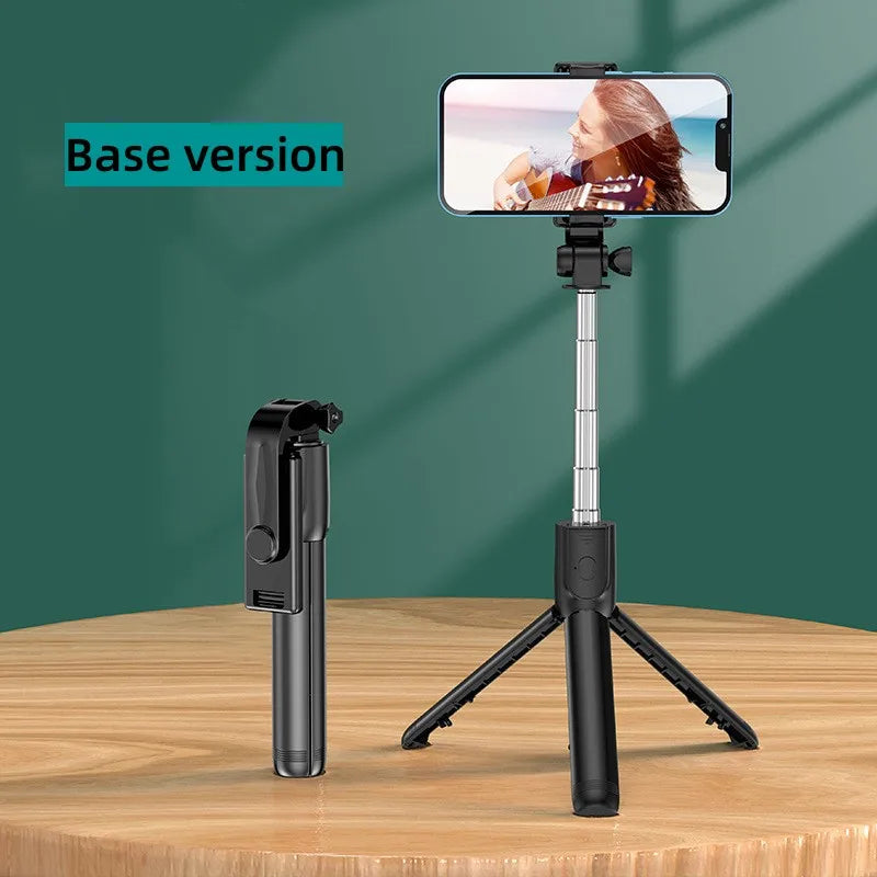 A black selfie stick tripod with a smartphone mounted, used for taking photos or videos.