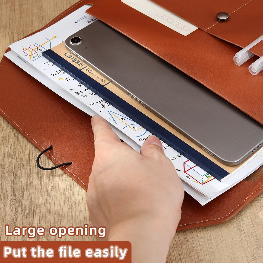 A hand is easily opening a leather document organizer bag to put a file inside.