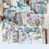 A collection of blue and purple floral papers, stamps, and decorative elements for a DIY scrapbook or journaling project.
