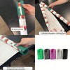 A hand is shown using a cylindrical paper cutting tool to cut wrapping paper.