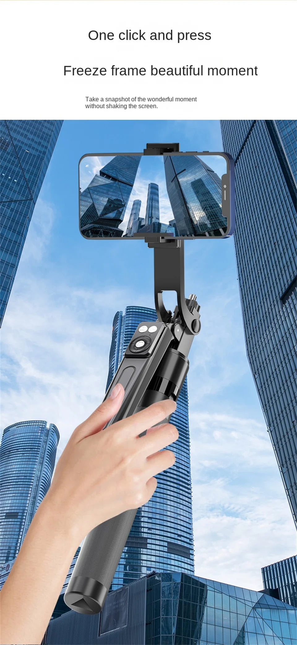 A hand holds a black 360° rotation selfie stick with a smartphone attached, capturing a cityscape through the lens.