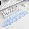 A light blue ergonomic cloud wrist rest designed for use with a keyboard and mouse.