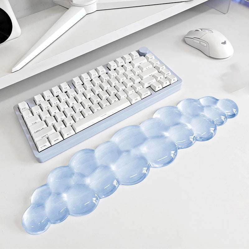 A light blue ergonomic cloud wrist rest designed for use with a keyboard and mouse.