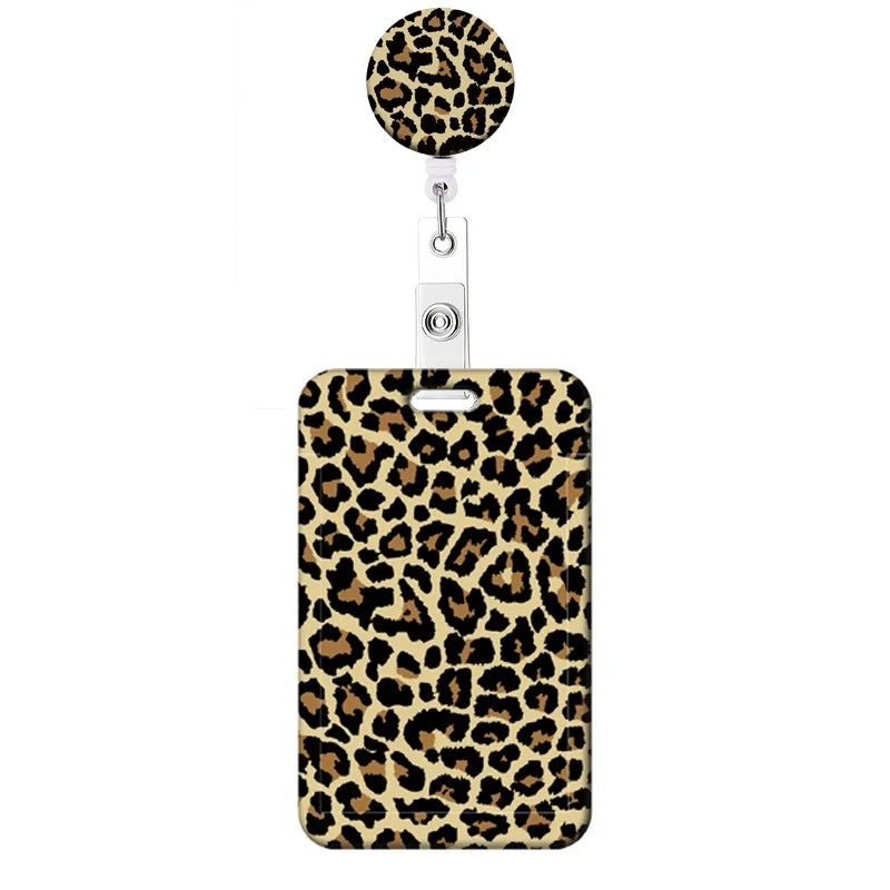 A leopard print retractable badge holder with a round charm.