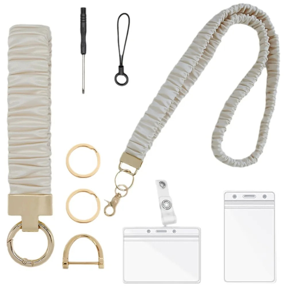 A beige stretchy breakaway ID badge lanyard with a retractable reel and various attachment options.