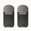 A pair of dark gray foldable laptop and tablet stands or risers.