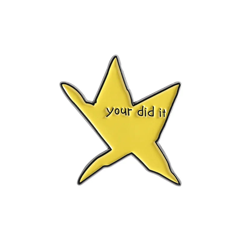A yellow star shaped enamel pin with the text your did it on it