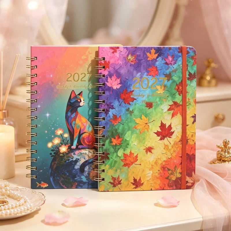 A colorful A5 spiral bound planner featuring autumn leaf designs and a cat illustration.