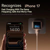 A hand holds an iPhone 17 Pro Max while it is charging via a dedicated smart display charger.
